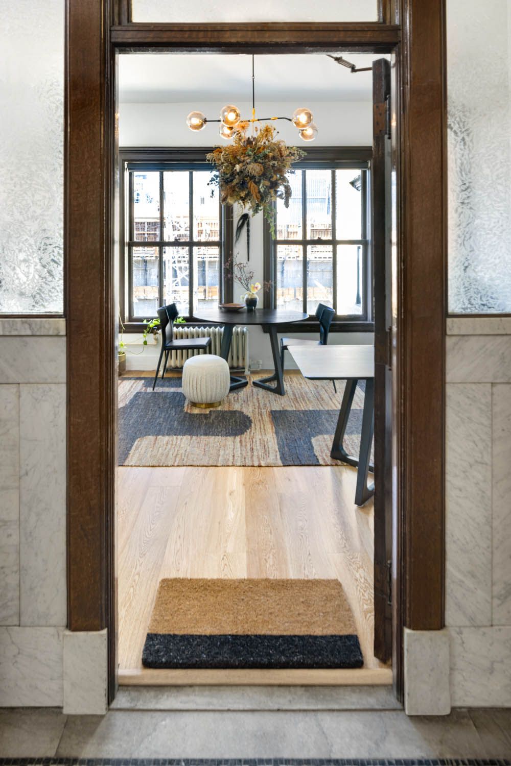 View from the heritage doorway into the office, with its round table and wool rug