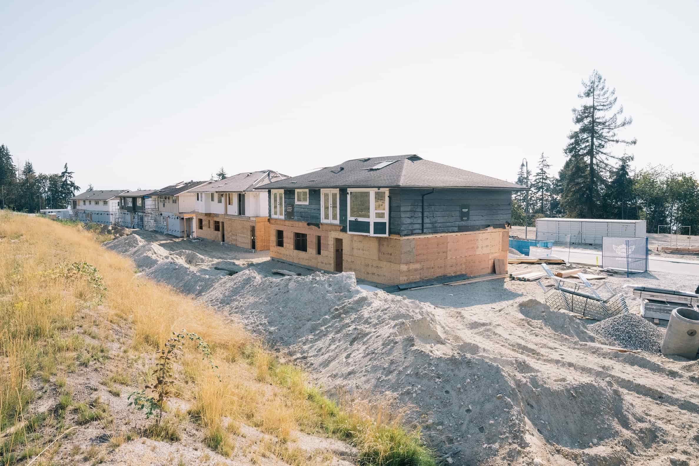 Relocated homes set on newly excavated foundations during construction of the subdivision