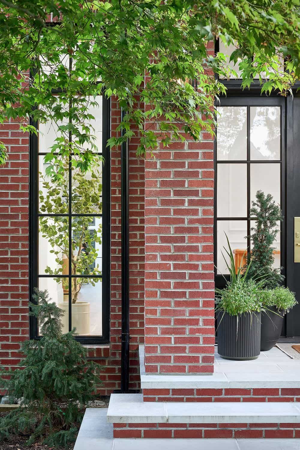 Detail of the brick pilasters, black downpipe and planted bluestone entry steps
