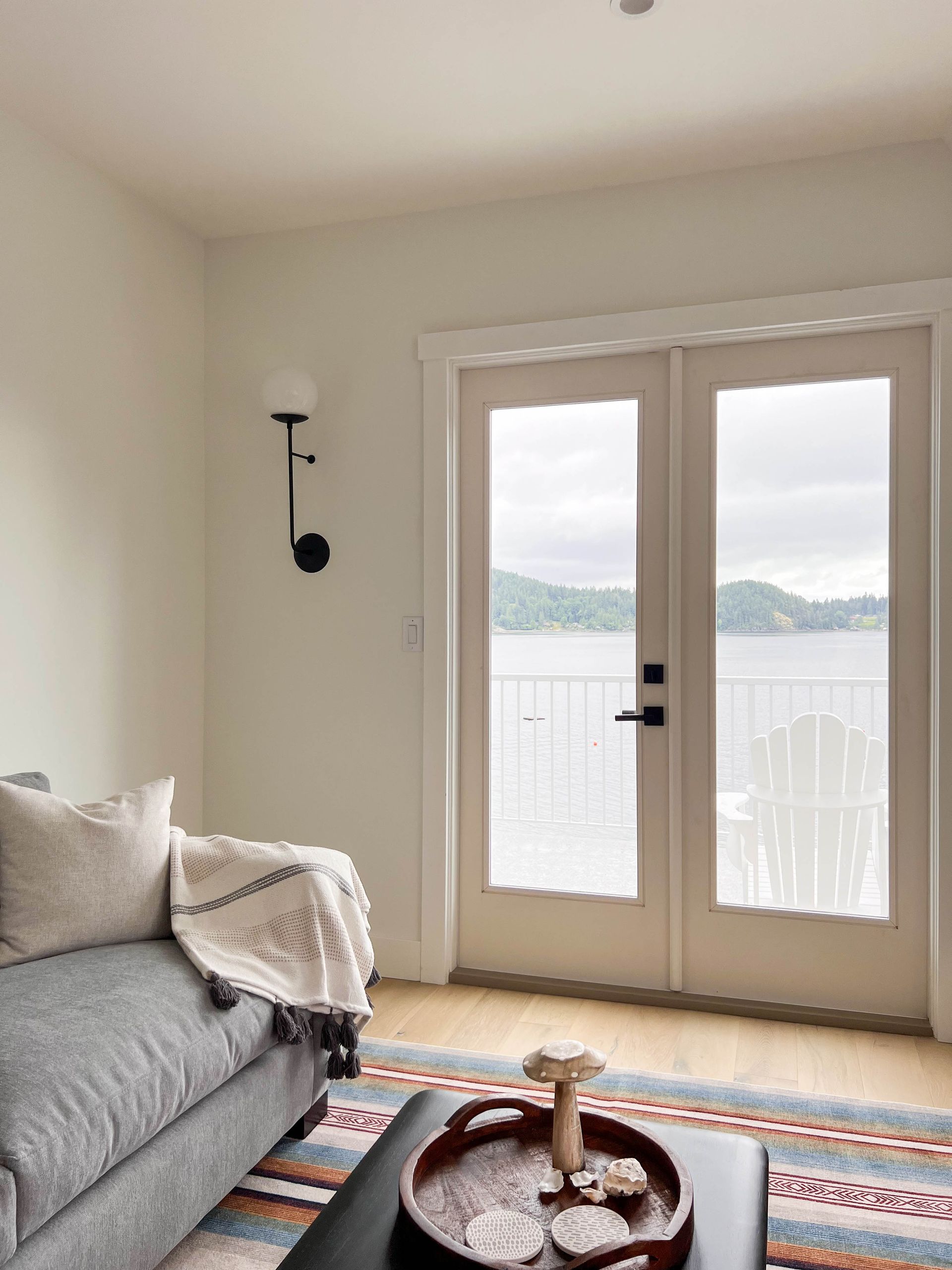 Sitting area with French doors opening onto the deck and the inlet beyond